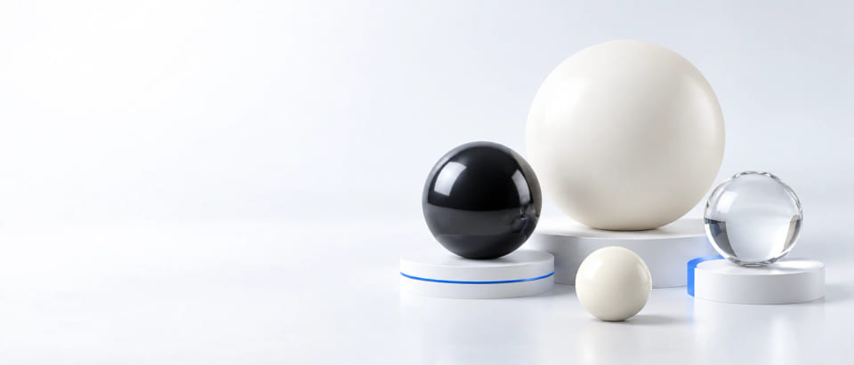 CGI concept of polymer, black ceramic and clear glass balls on light studio plinths